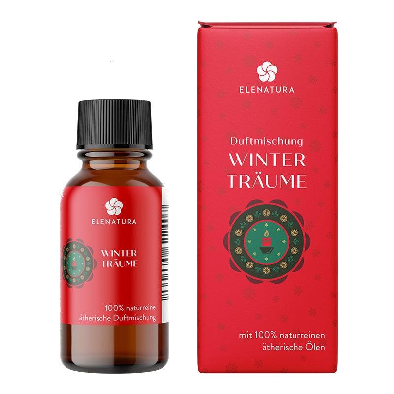 Flasche Duftmischung Winterträume 10 ml mit Mandarine, Rose und Ho-Blättern auf winterlichem Hintergrund